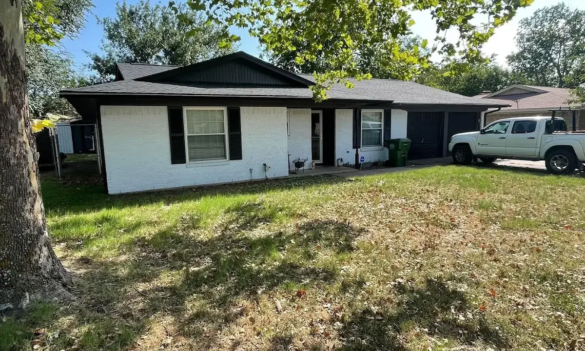 Professional roofing crew working on a residential roof in Sutherlin